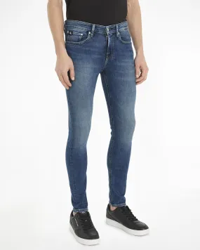 Jeans skinny-fit a vita bassa in cotone stretch lavaggio medio con sabbiature